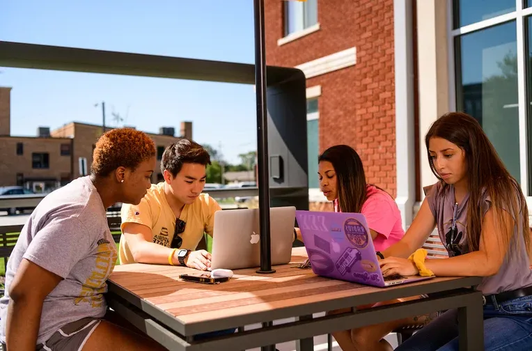 Students studying in front of Schallenkamp Residence Hall