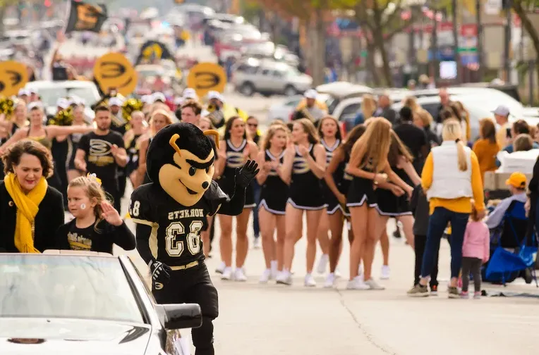 Corky and Cheerleaders Marching in Homecoming Parade