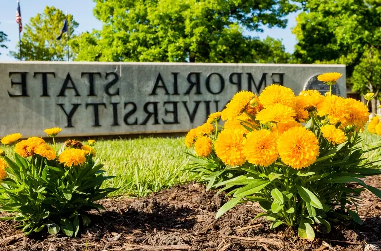 Emporia State University sign flanked by flowers